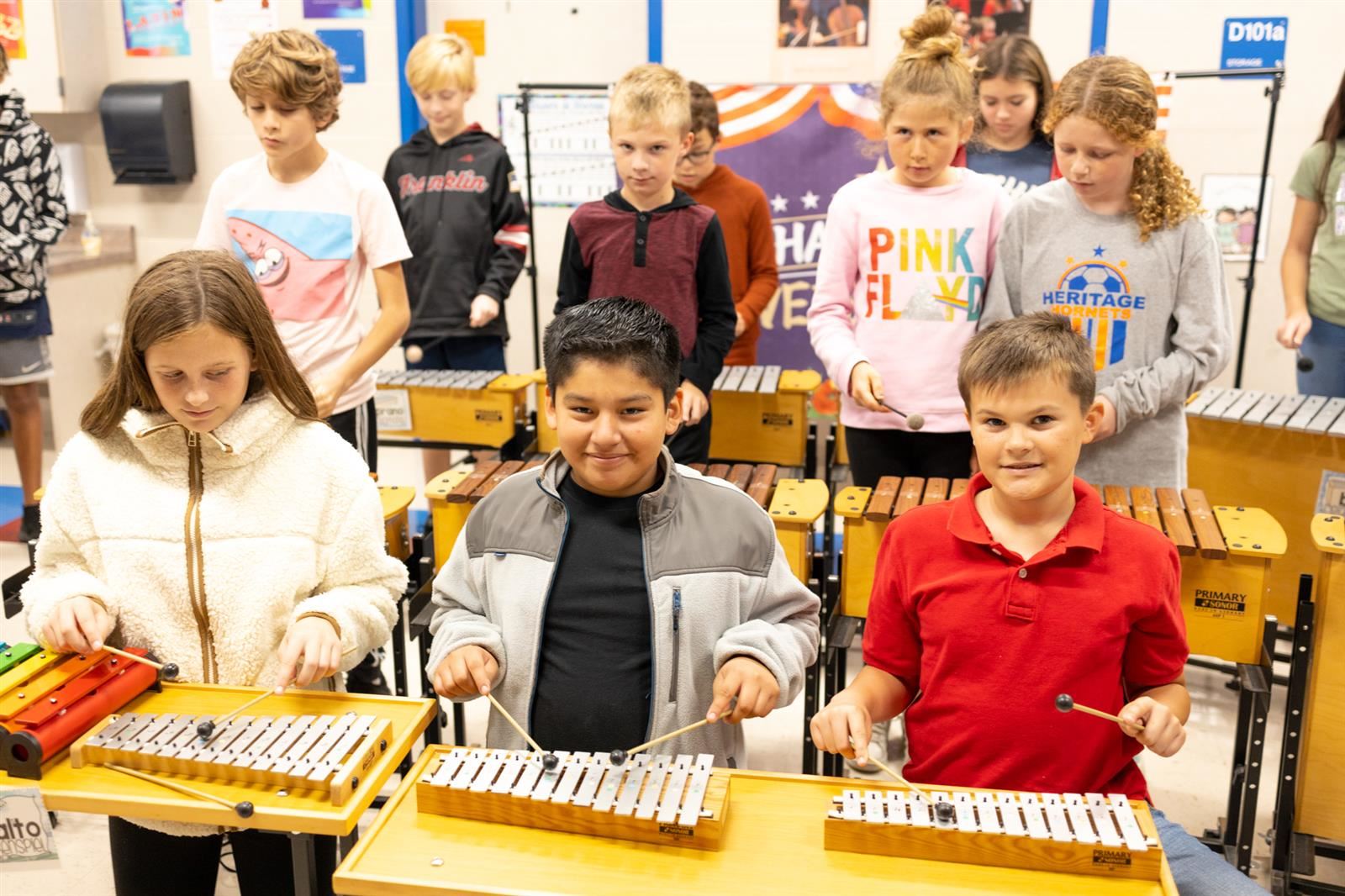 Many students playing instruments in Music